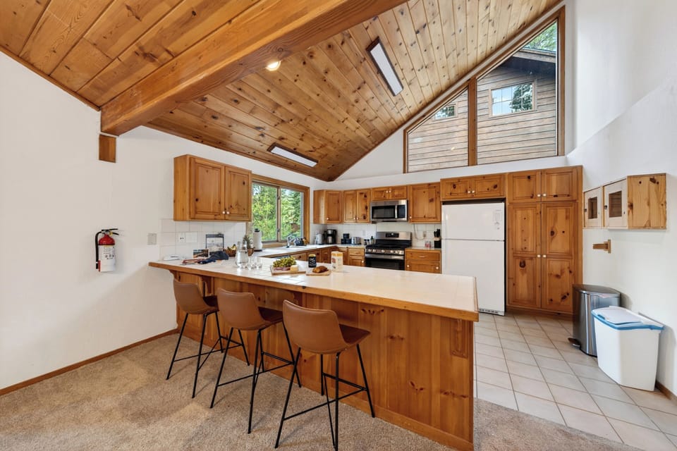 Well-appointed kitchen wrap-around countertop showing the stainless steel dishwasher and gas range.