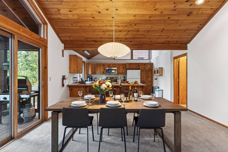 Gourmet kitchen featuring ample wood cabinetry, a raised breakfast bar with seating, and durable tile flooring.