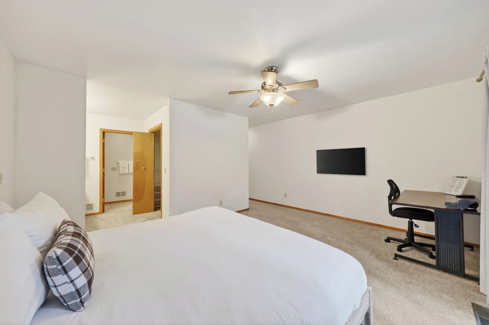 The primary bedroom features a king bed with a TV.