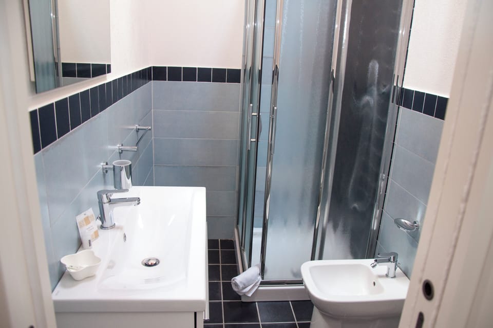 Shower, hair dryer, towels, toilet paper