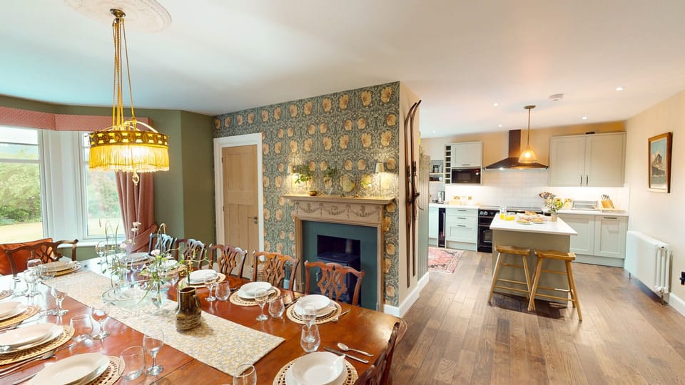 Gather the whole group around the grand dining table for a feast — the elegant dining room at Lynwilg is made for memorable meals together.