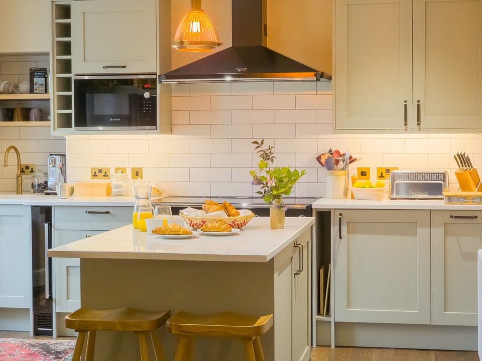 The kitchen island is perfect for casual breakfasts or afternoon treats — spacious, stylish and ready for a crowd.