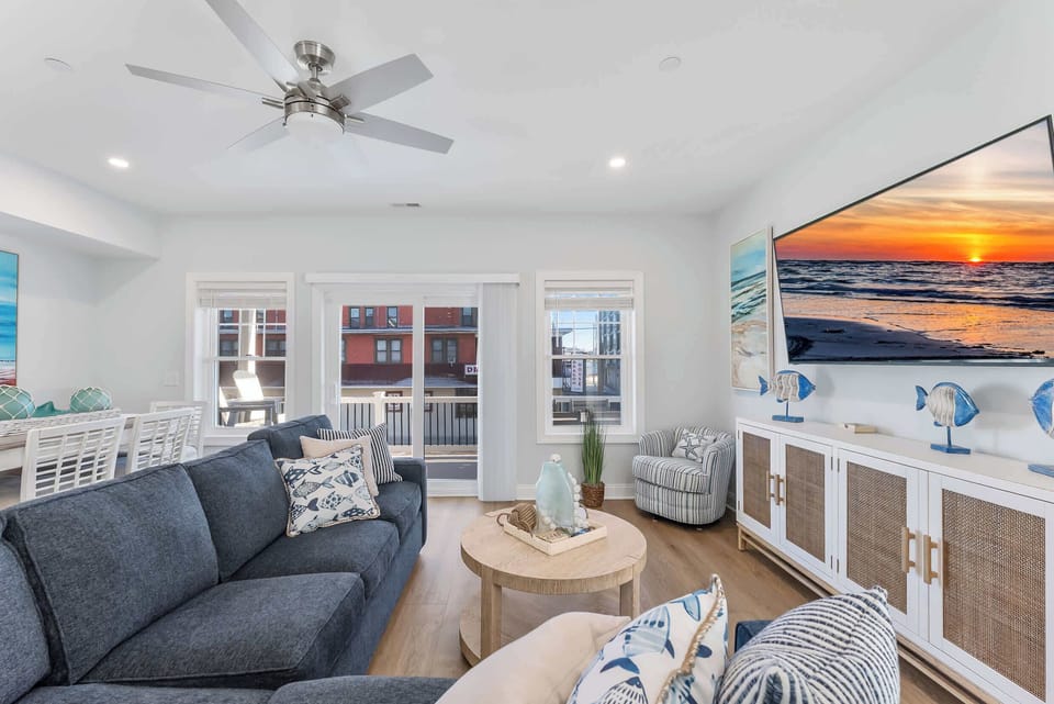 Relax with family and friends in the spacious living area with balcony access and a smart TV.