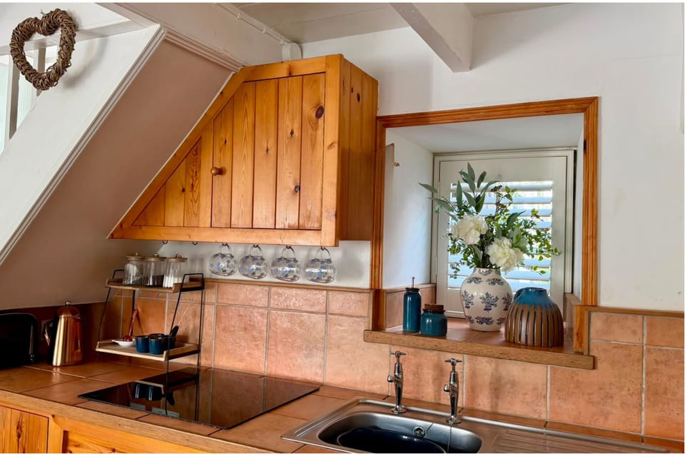 Characterful cottage kitchen with rustic wooden cabinetry