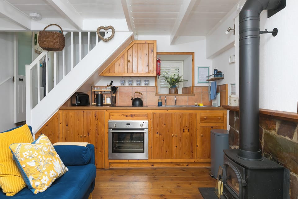 Open-plan kitchen with oven, hob, coffee station and thoughtful extras
