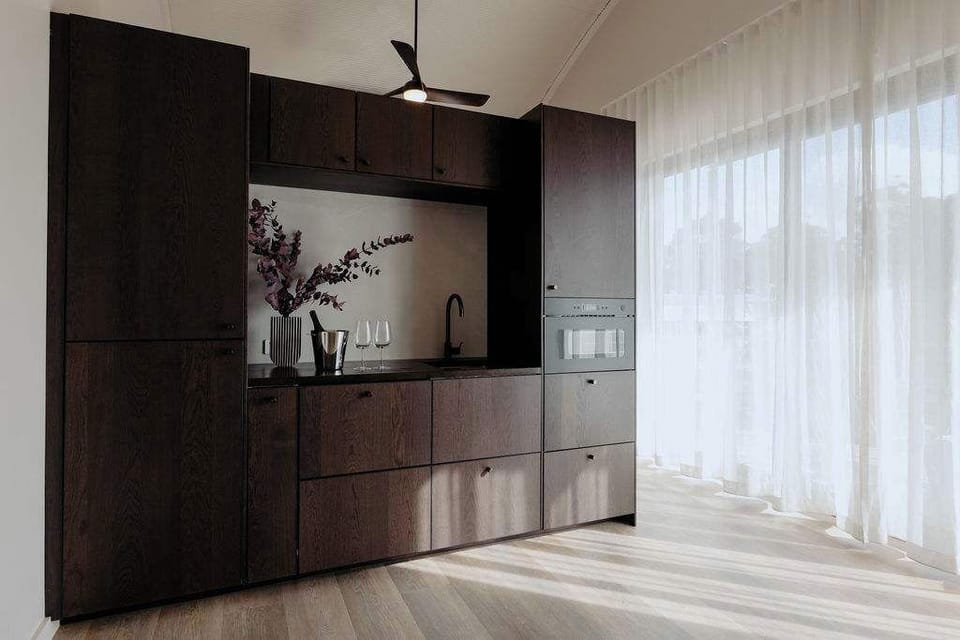 Minimal kitchen styling balanced with warmth and natural light.