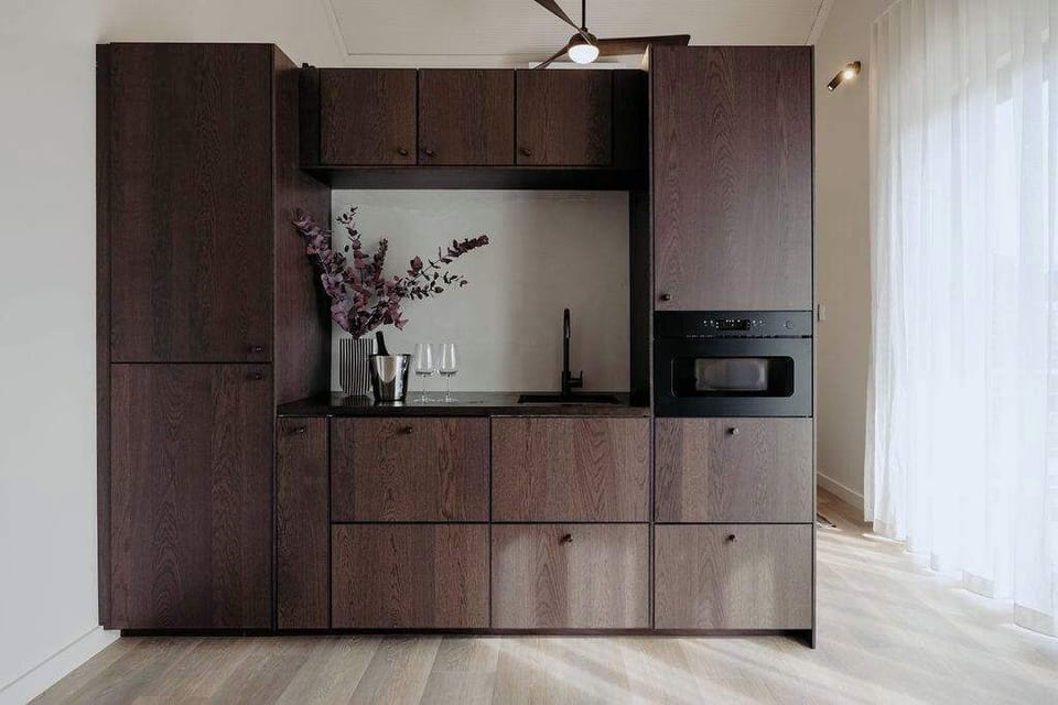 Compact kitchen space designed for relaxed in-studio dining.