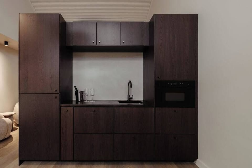 Compact kitchen space designed for relaxed in-studio dining.