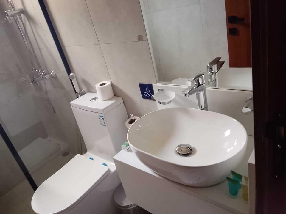 Shower, hair dryer, slippers, towels
