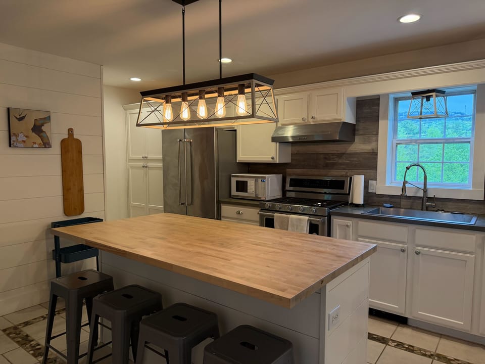 There is room for the whole family in the kitchen with island seating, peninsula seating and open to large dining table