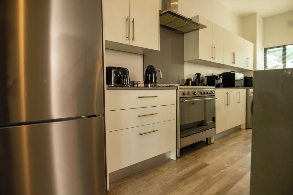 Modern fully equipped kitchen with fridge, stove,microwave, kettle and air fryer