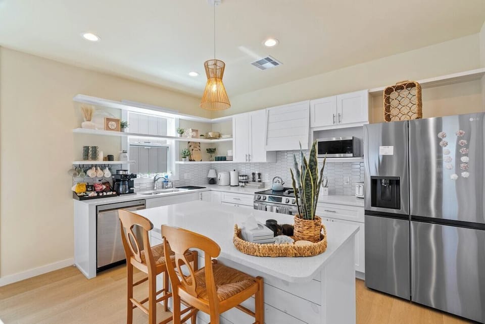 Additional great angle of the open-concept kitchen with a dedicated coffee bar, stainless steel appliances, and plenty of space to cook and gather.