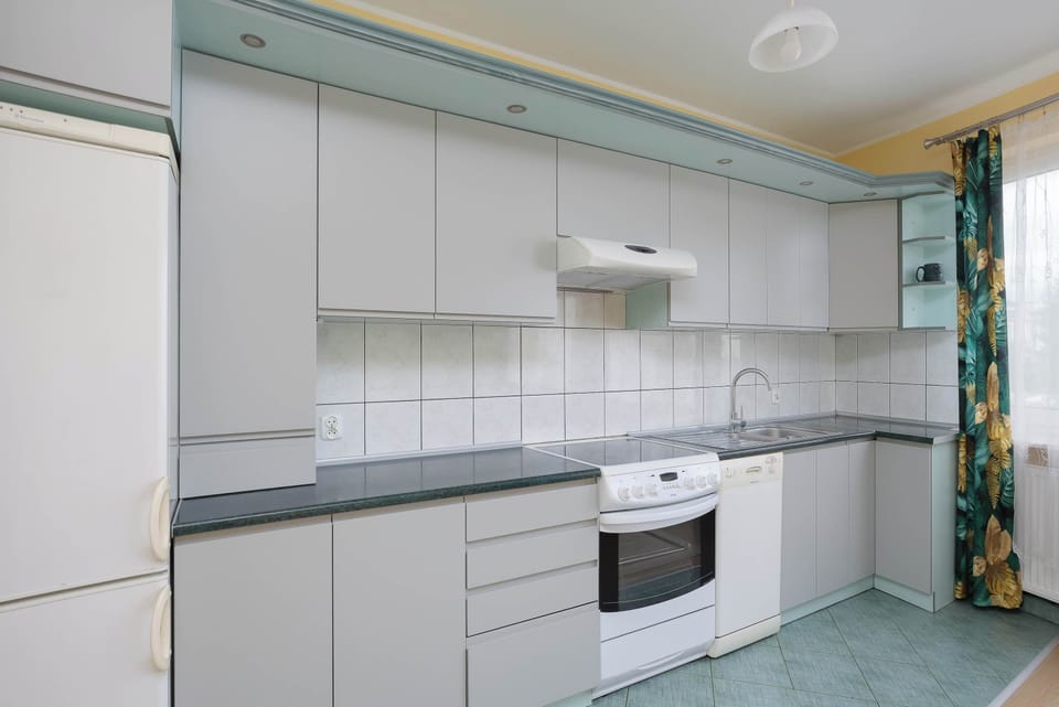 Kitchenette equipped with essential appliances and storage space.