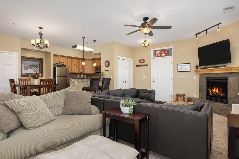 Unwind in your spacious open-concept living area, complete with plush seating, a warm fireplace, and a fully-equipped kitchen for your home-away-from-home comfort.