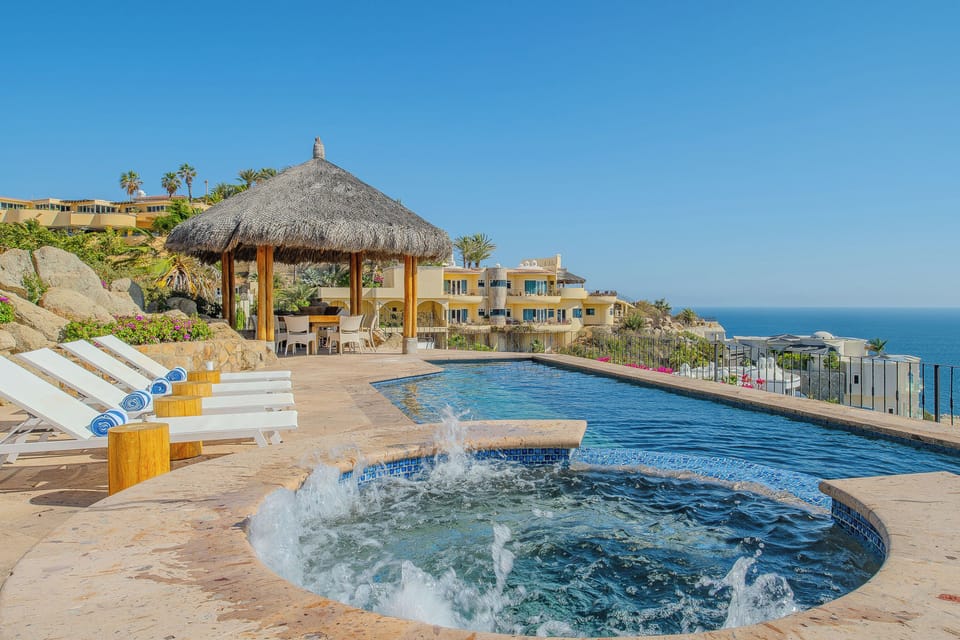 Unwind by your private pool with bubbling spa jets while taking in stunning ocean views from this hillside paradise.