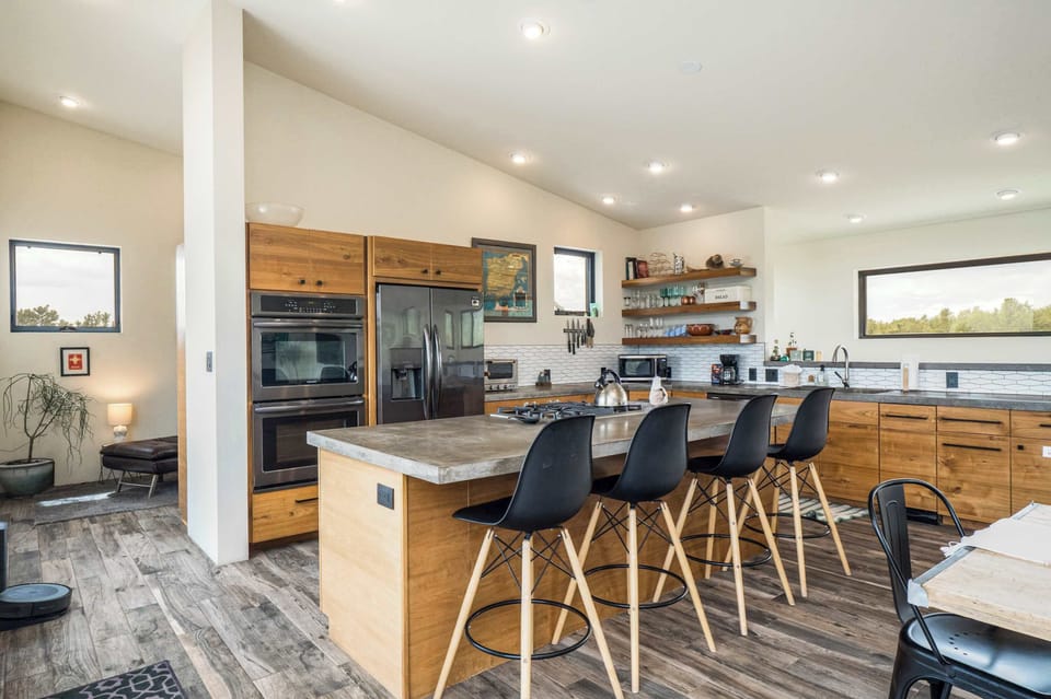 Vaulted kitchen with double ovens and island seating