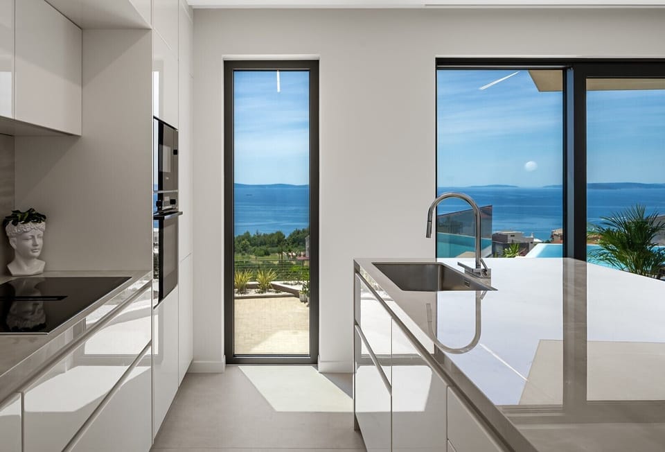 Fully equipped kitchen featuring modern amenities and spectacular sea views.