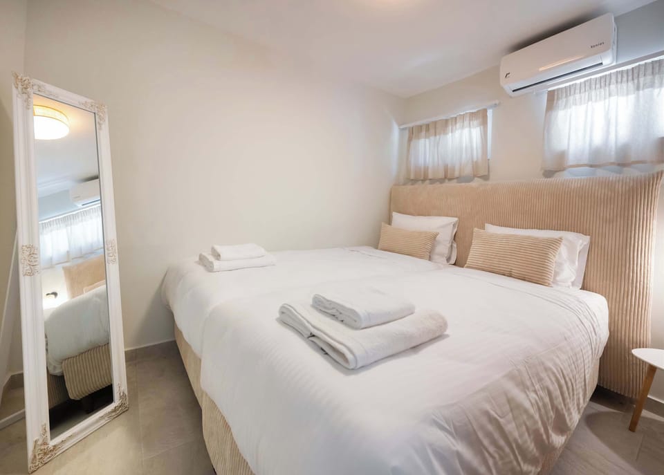 Soft curtains, fresh linens, and warm bedside lighting create an inviting bedroom after a full day around Nidri.