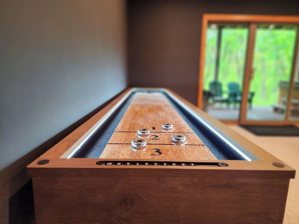 Turn a quiet evening competitive — the game room has warm tones, an open layout, and a lineup that works for your whole group.