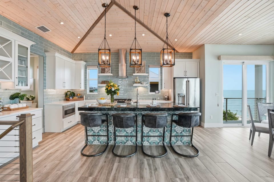 Bright, open kitchen with coastal finishes, generous island seating.  
