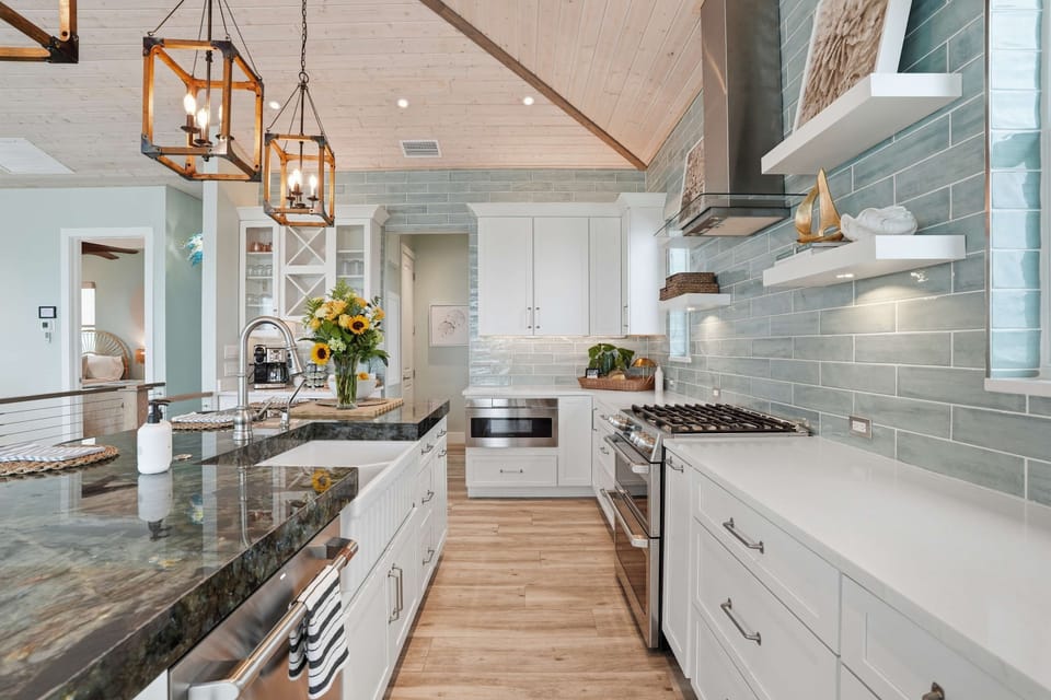 Chef-inspired coastal kitchen with elegant finishes, spacious prep areas, and a bright open layout designed for gathering and entertaining.