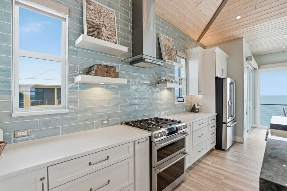 The chef will love cooking on gas range, Café appliances, and upscale coastal finishes designed for effortless entertaining.