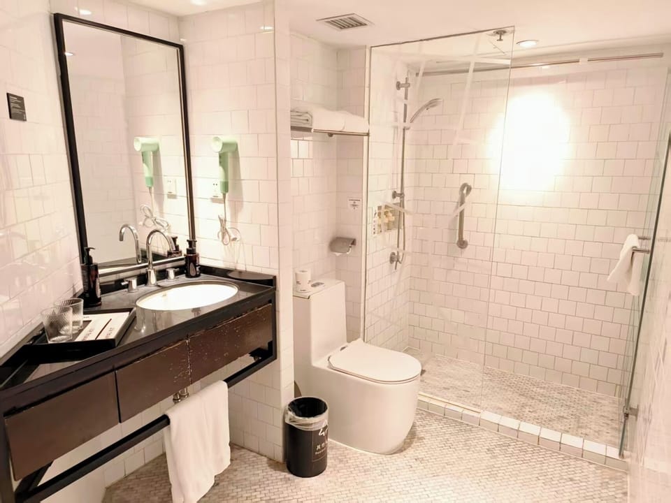 Comfort King Room | Bathroom | Hair dryer, slippers, towels, soap