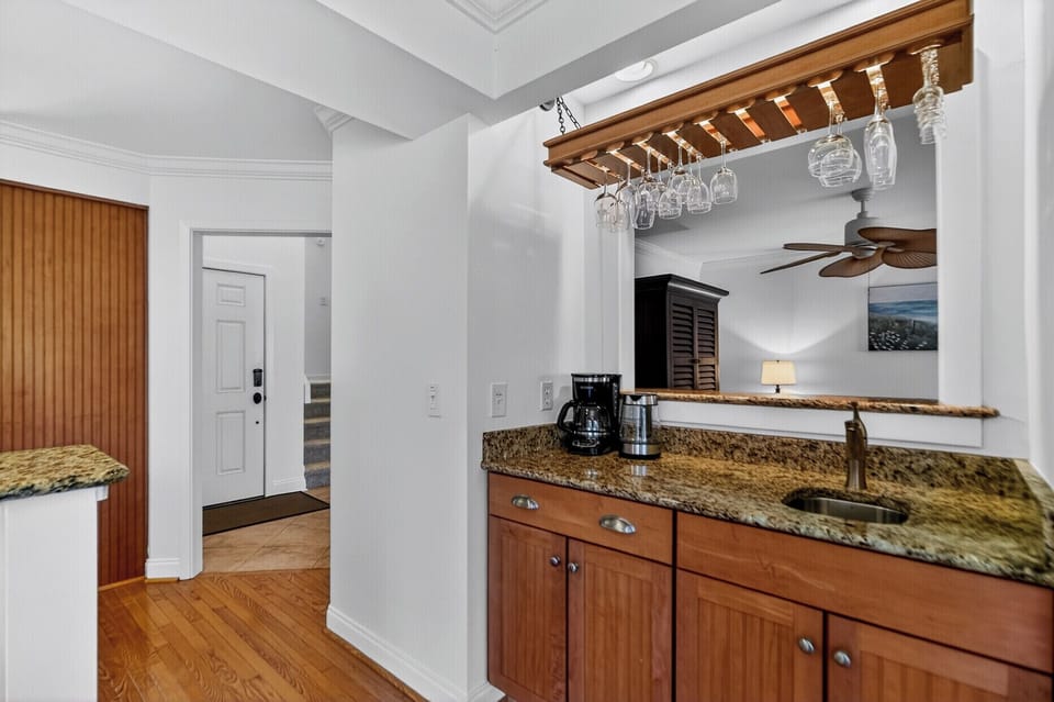 Your private wet bar features granite countertops, a sink, coffee maker, and charming wine glass rack—perfect for relaxing after a day of adventure.