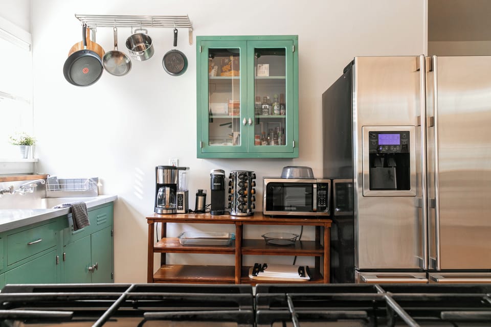 Bright kitchen with gas stove, dishwasher & charming teal cabinets