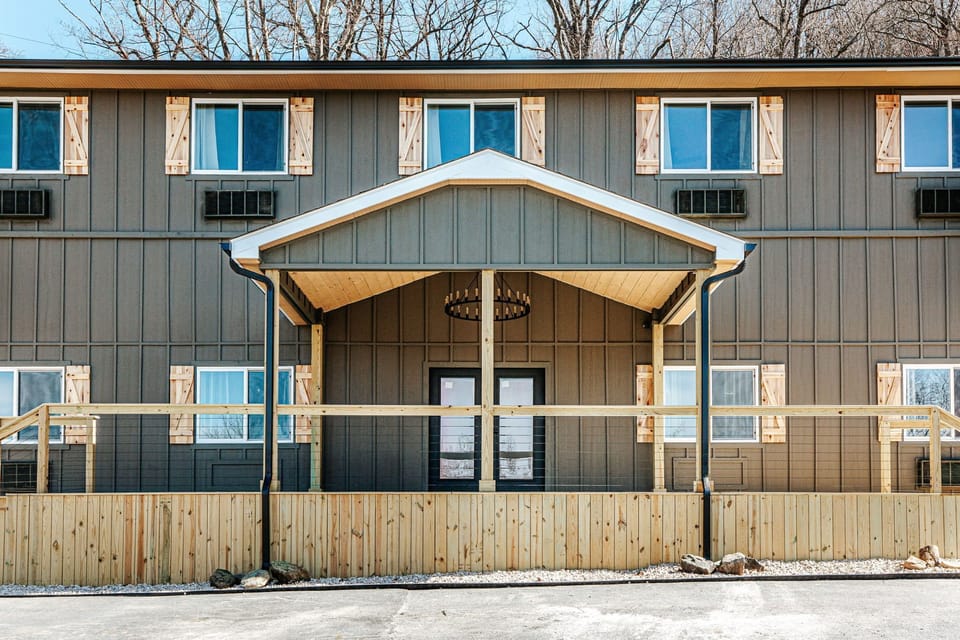 Admire the charming facade, featuring wooden accents and ample natural light.