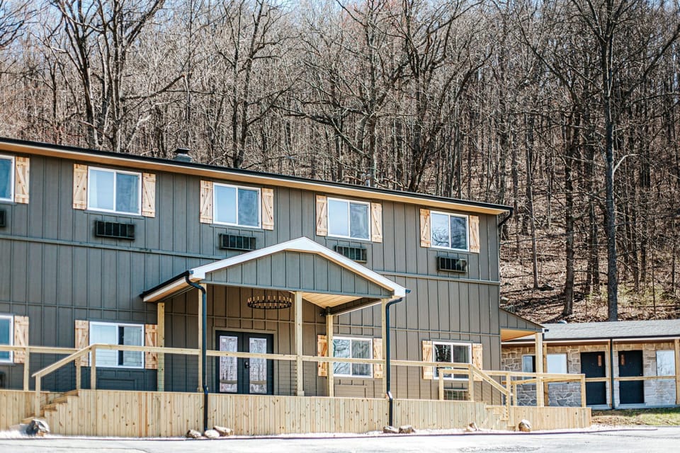 Experience a welcoming exterior set against a serene backdrop of bare trees. Nature is just a step away.