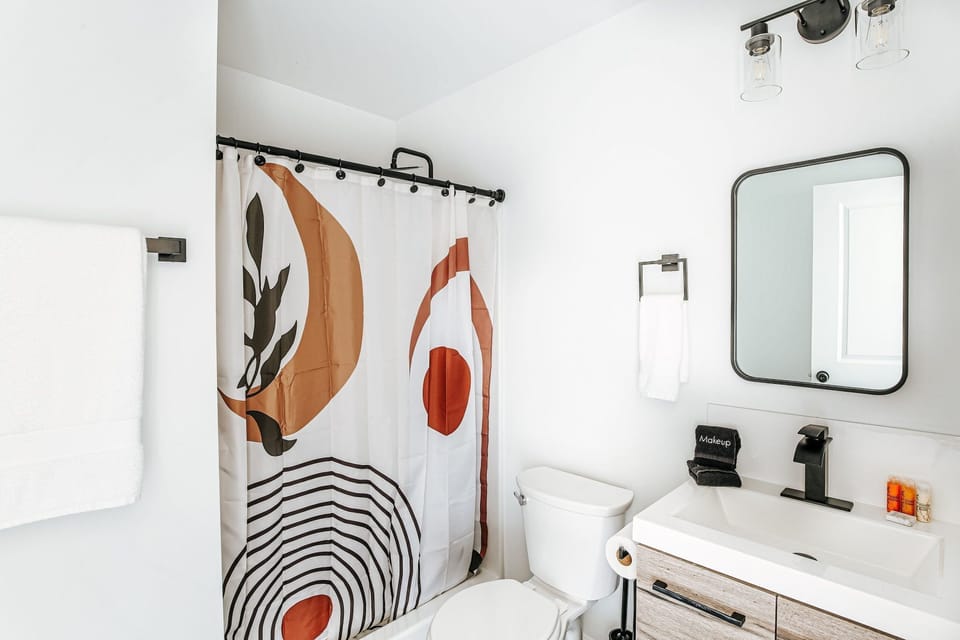 Fresh and modern, this bathroom features chic decor and essential amenities for your convenience.