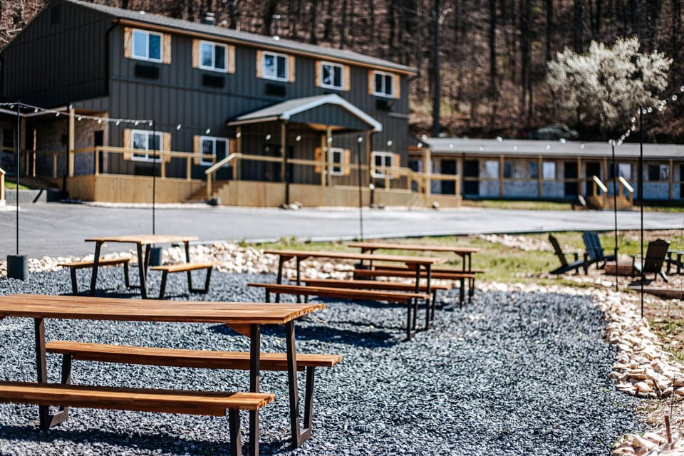 Enjoy outdoor dining with sleek wooden tables set amidst natural stone paths.
