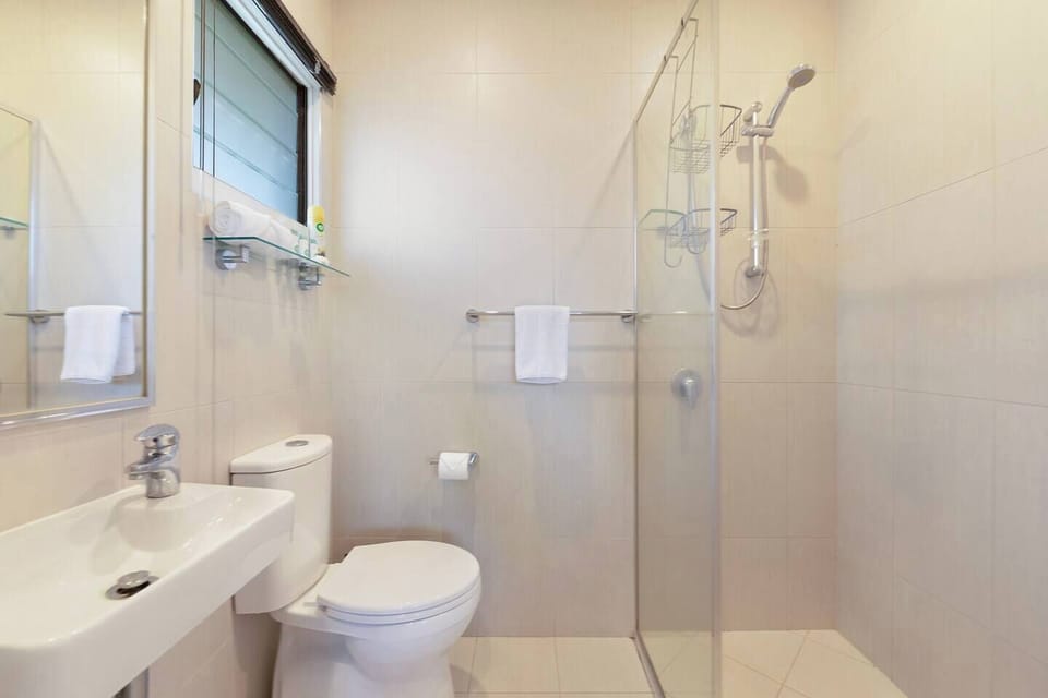 Refresh in the ensuite, where a walk-in shower and essentials provide a convenient start to busy days exploring the city.