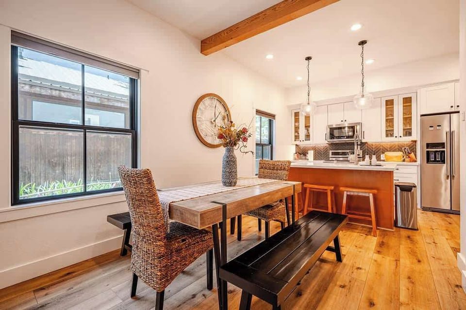 Dining area: Dining table with seating for 8, bar with 3 barstools, and a gas fireplace
