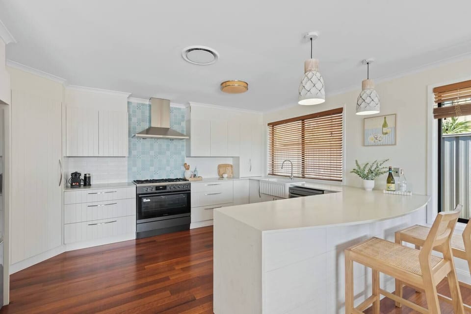 Create everything from casual breakfasts to family feasts in the spacious kitchen, where generous bench space and quality appliances make cooking feel effortless.