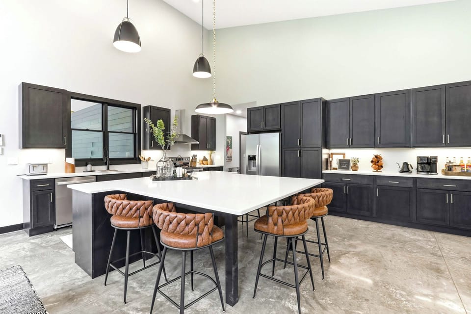 Gather with ease in a polished chef’s kitchen, where an oversized island, warm seating, and sleek finishes make every meal feel effortlessly elevated.