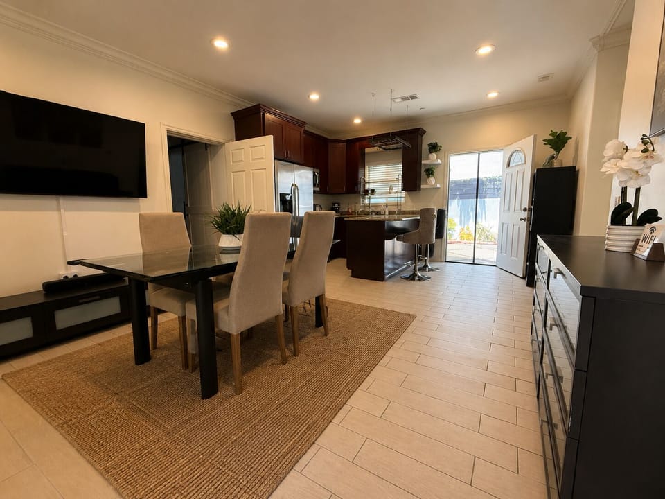 Bright open dining & kitchen space with island seating and patio access