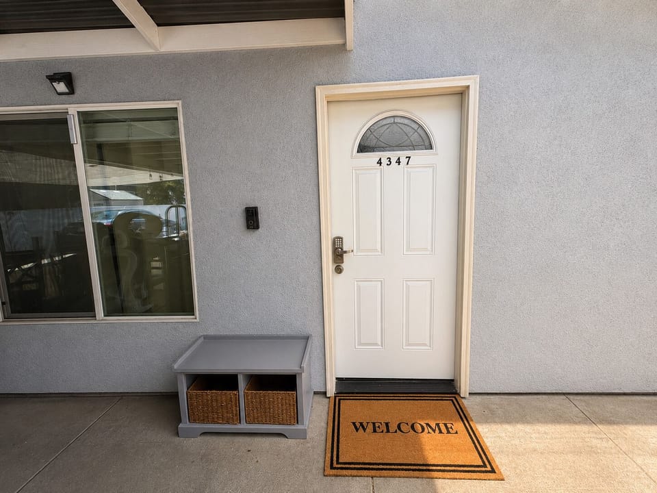 Welcoming covered entry with keyless check-in and stylish curb appeal