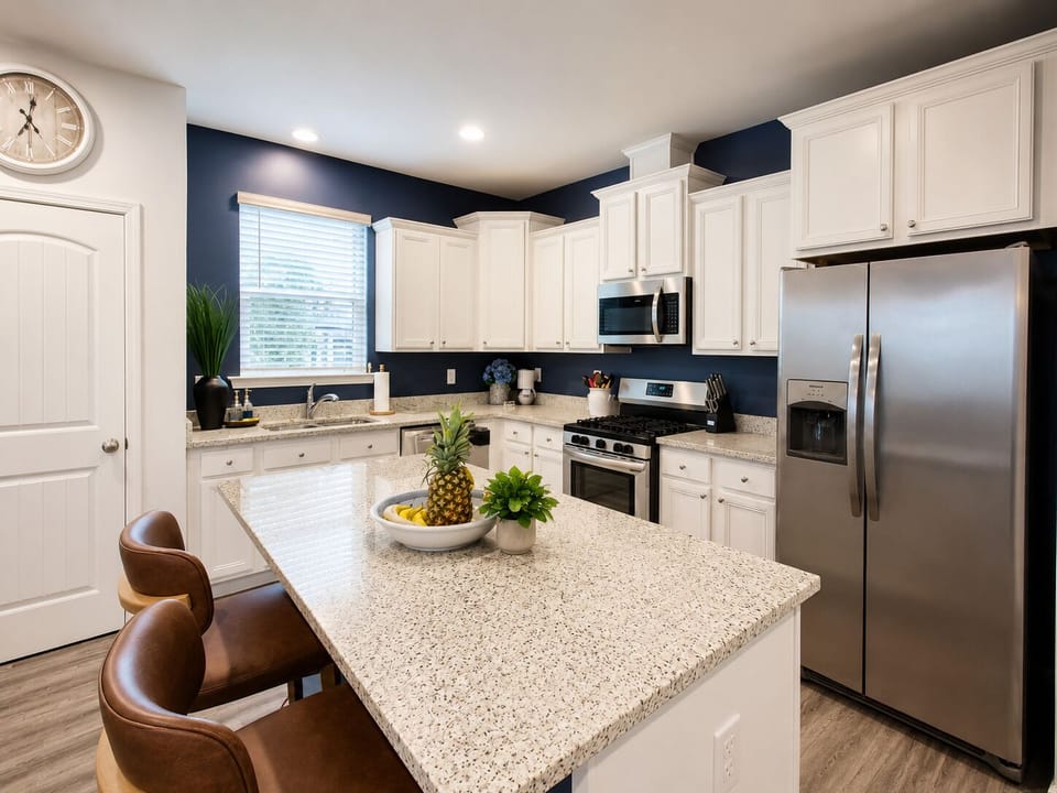 Bright modern kitchen with granite island and stainless steel appliances