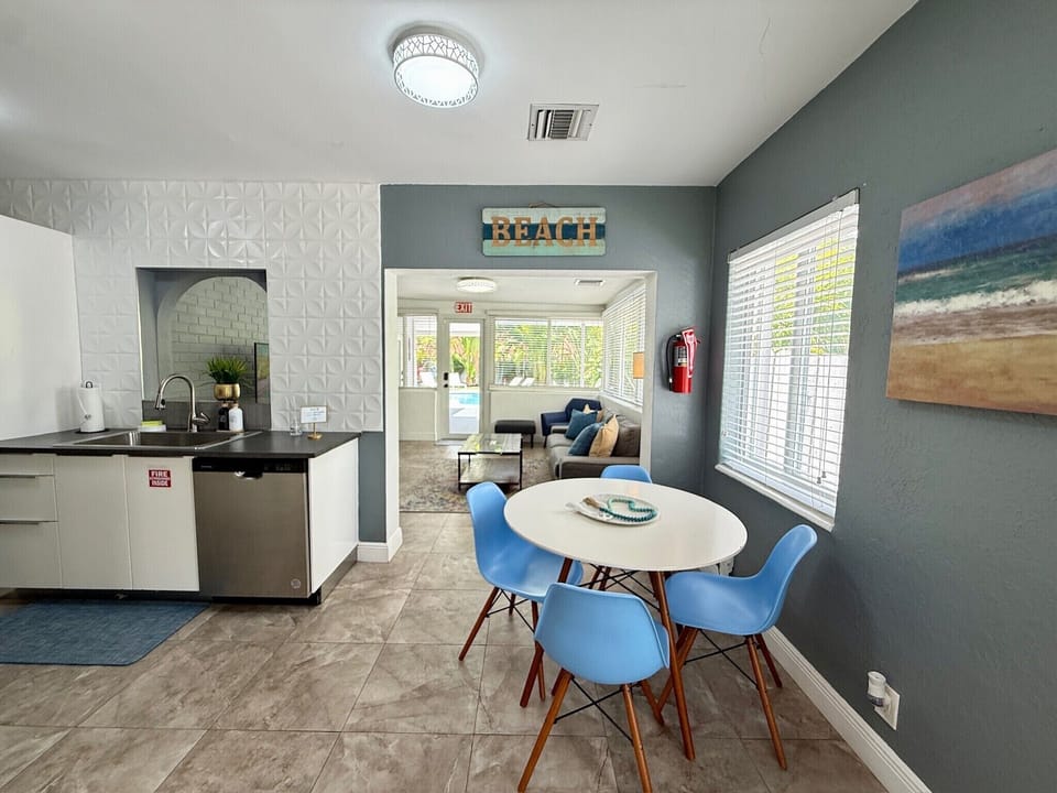 Bright coastal dining nook with kitchenette and airy lounge space