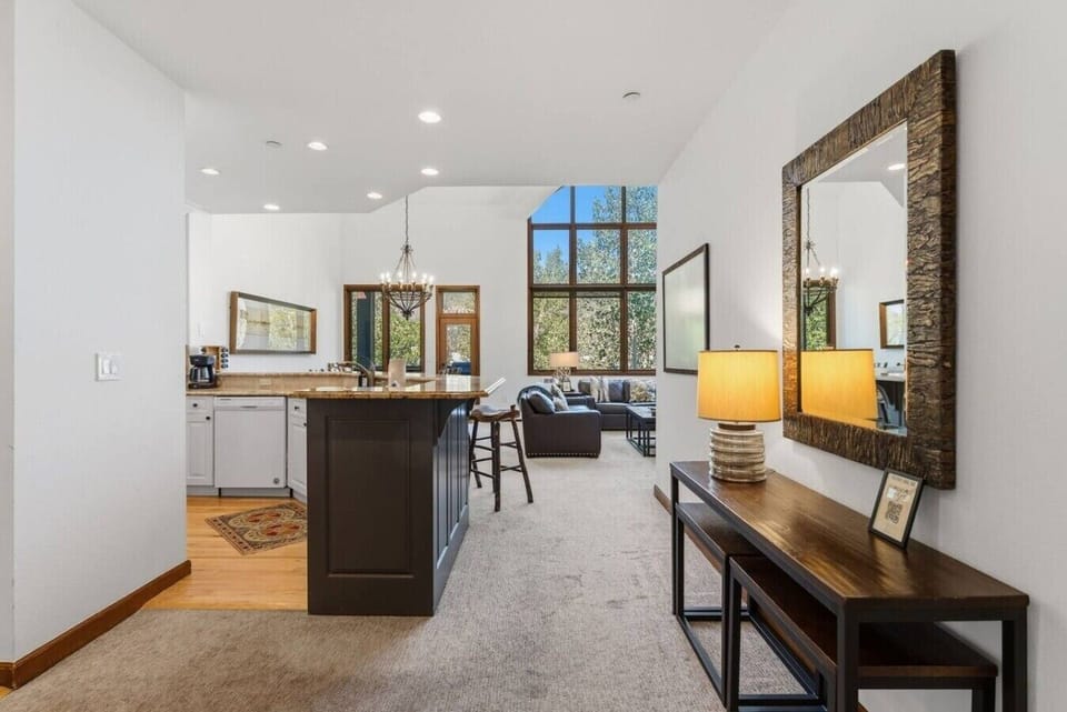 Spacious living room with vaulted ceilings, tons of natural light, fireplace and smart tv