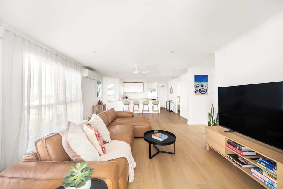 The spacious open-plan design brings together the living area, kitchen and dining spaces, creating an easy setting for spending time together throughout your stay