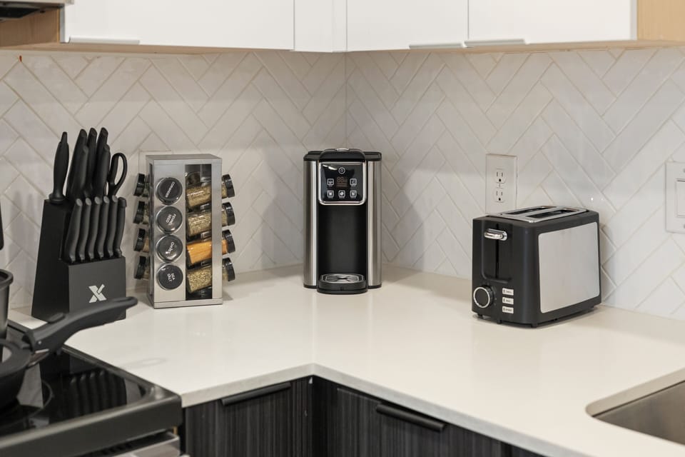 Convenient kitchen coffee station with a single-serve coffee maker, pod organizer, toaster, and ample counter space for easy morning routines.