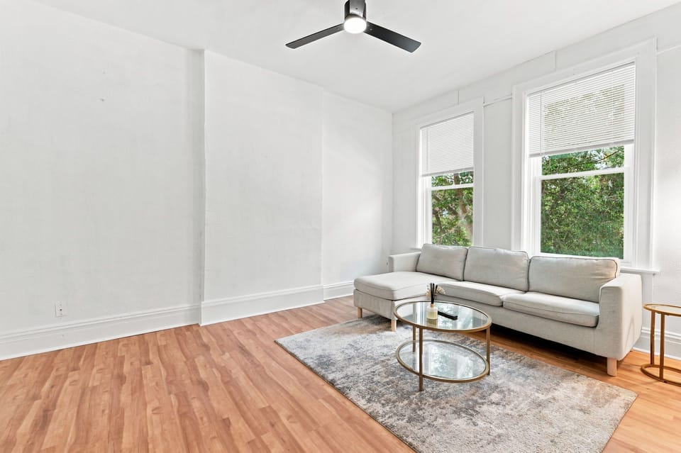 Bright, airy living room with tall windows and modern seating