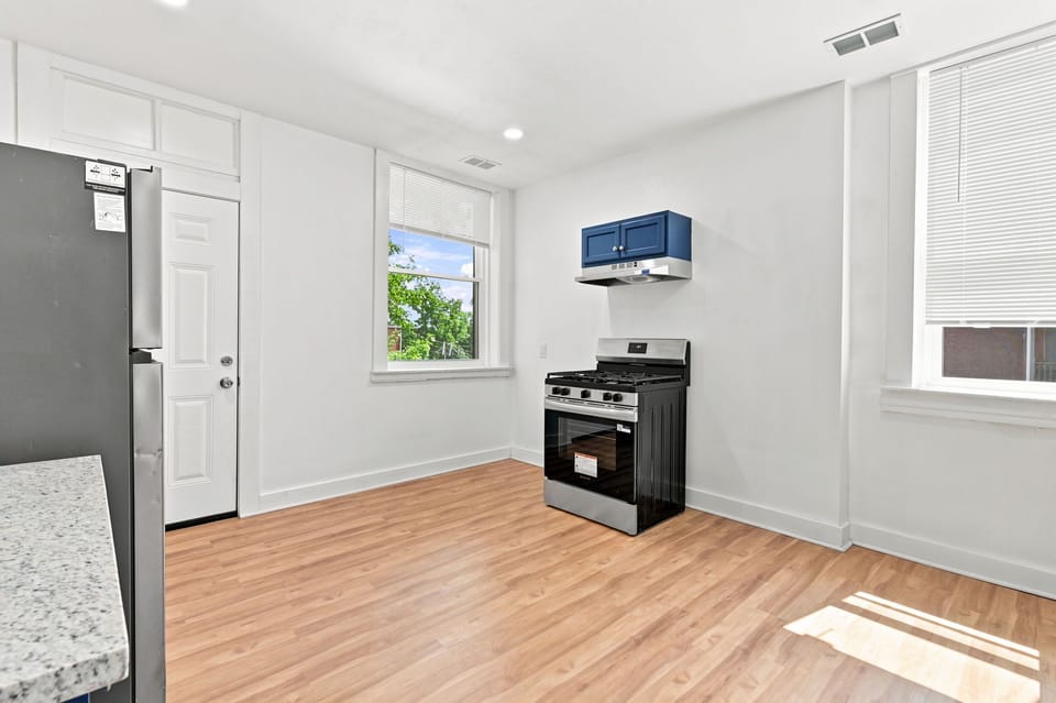 Bright, airy kitchen with natural light and modern stainless appliances