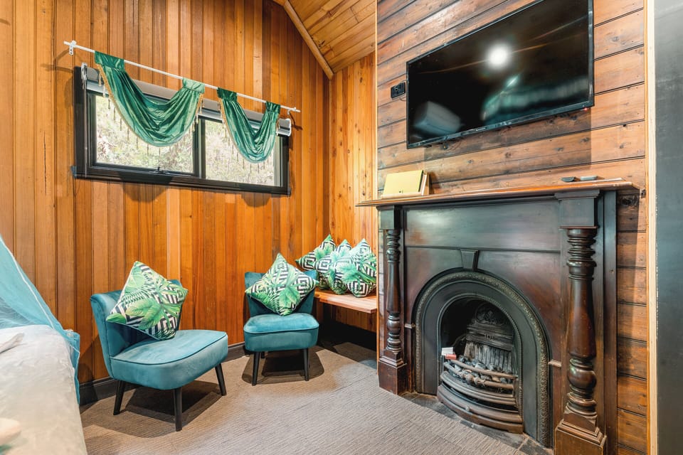Rustic wood retreat with vintage fireplace, window nook and TV-ready lounge