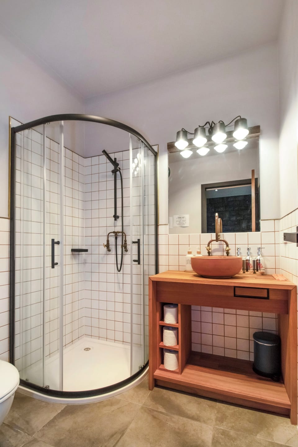 Modern tiled bathroom with sleek glass shower and warm wood vanity