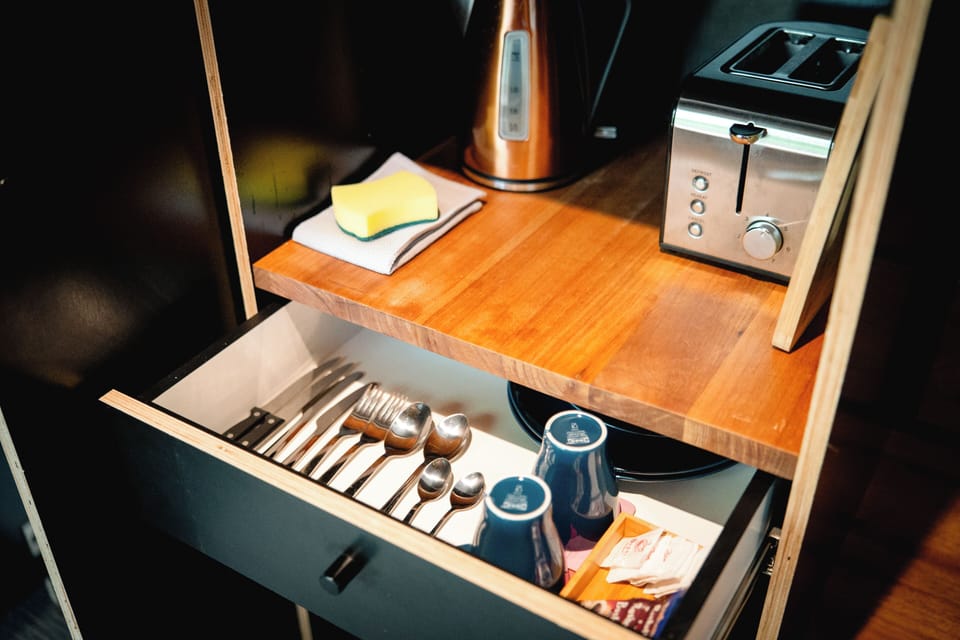 Breakfast-ready kitchenette with toaster, kettle, and stocked essentials