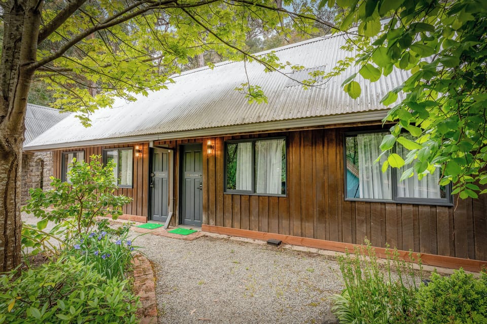 Charming woodland cottage with twin entries, garden path, and tranquil vibe